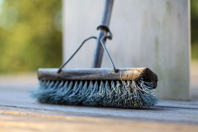 Close-up of broom on footpath