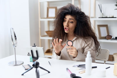 Portrait of young businesswoman working at table