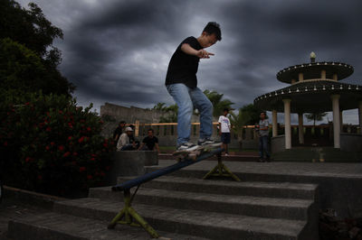 Man skateboarding on railing in park