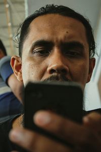 Low angle close-up of man using mobile phone