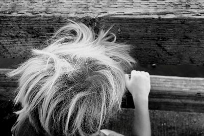 Rear view of woman with arms raised