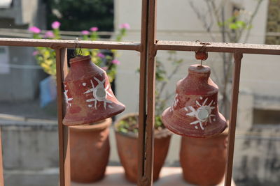 Close-up of bells hanging from railing