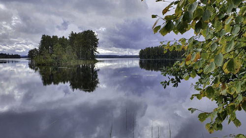 Reflection of trees in lake against sky