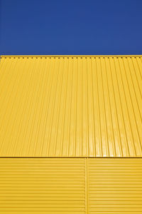 Background pattern yellow galvanized metal profile against the sky