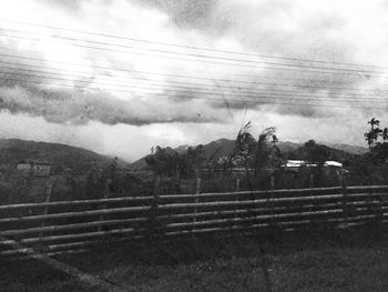 Scenic view of field against cloudy sky