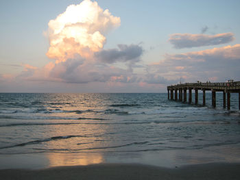 Scenic view of calm sea against cloudy sky