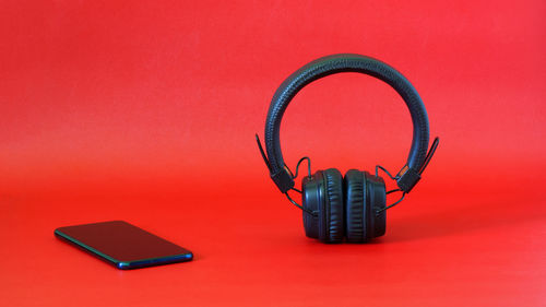 High angle view of laptop on table against red background