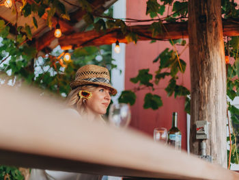 Portrait of young woman looking away outdoors