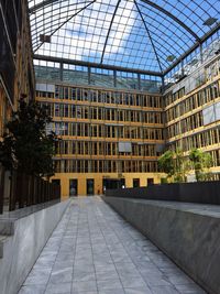 Footpath amidst buildings in city