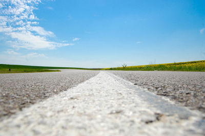 Surface level view of country road against sky