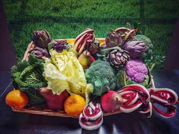 High angle view of various fruits in basket on table