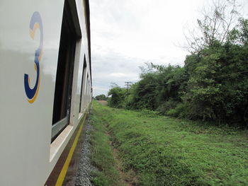 Train on railroad track amidst trees against sky