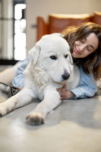 Portrait of woman with dog at home