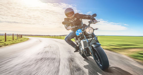 Man riding motorcycle on road