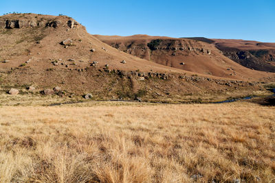 Scenic view of arid landscape against clear sky