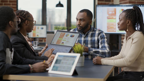 Businessman with colleagues discussing work at office