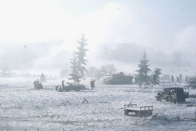 Boats sailing in sea against sky during winter