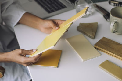 Cropped hand of man working on table