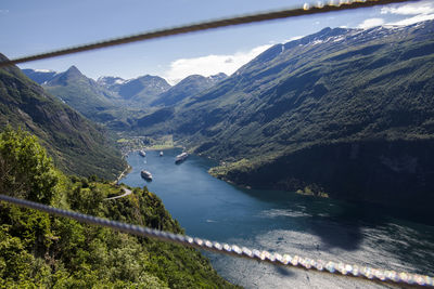 Scenic view of river amidst mountains against sky