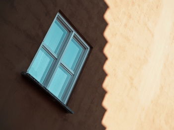 Low angle view of window on wall of building