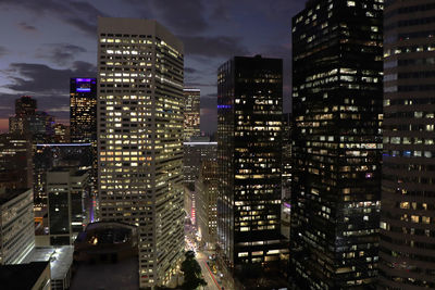 Aerial view of illuminated buildings in city at night