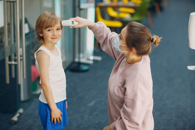 Mother and daughter standing on floor