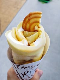 Close-up of hand holding ice cream