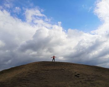 Man standing on field against sky