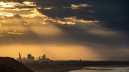 View of sea against cloudy sky during sunset