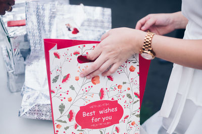 Hand holding a gift in paper bag