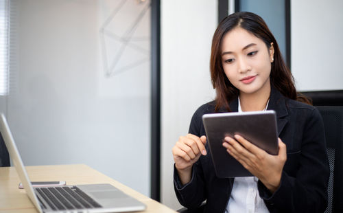 Young woman using digital tablet