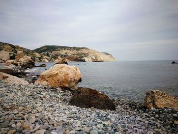 Rocks on beach against sky