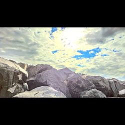 Scenic view of mountains against cloudy sky