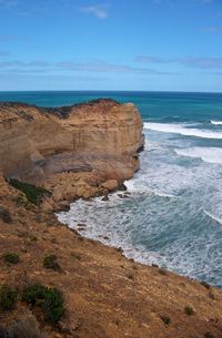 Scenic view of beach against blue sky