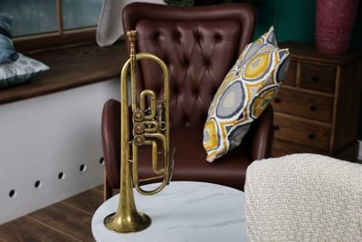 Close-up of saxophone on table at home