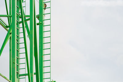 Part of roller coaster against cloudy sky