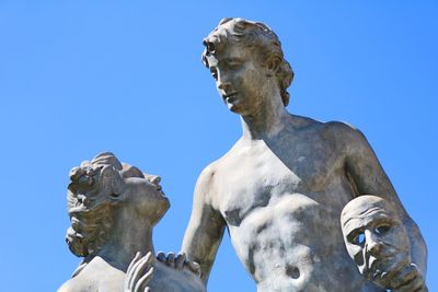 Low angle view of statue against clear blue sky