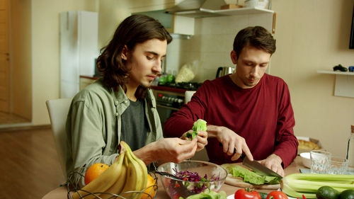 Young couple preparing food in kitchen at home