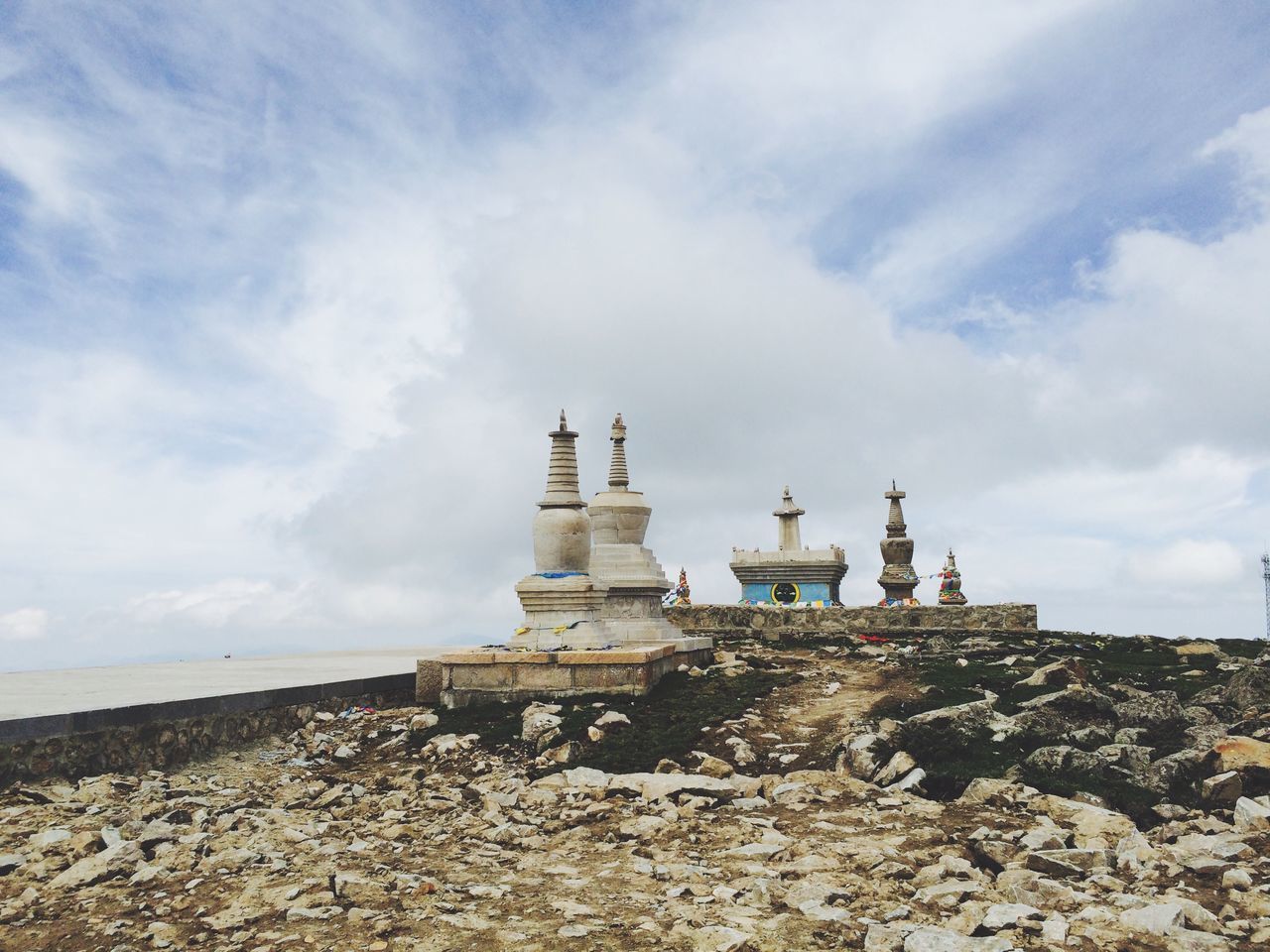 sky, built structure, cloud - sky, beach, architecture, building exterior, cloud, sea, sand, lighthouse, cloudy, tranquility, day, shore, nature, horizon over water, tranquil scene, outdoors, scenics, protection