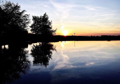 Scenic view of lake at sunset