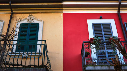 Low angle view of building with two balcony and two different contrasting colors