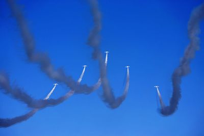 Low angle view of vapor trail against blue sky