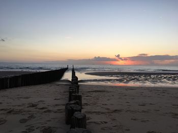 Scenic view of beach against sky during sunset