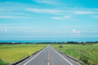 Empty road along countryside landscape