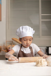 Portrait of boy with ice cream in kitchen