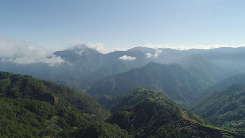 Aerial view of rice terraces and agricultural land on the slopes of the mountains. 