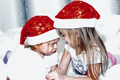 Low angle view of mother and girl wearing hat
