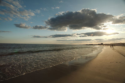 Scenic view of beach against sky during sunset