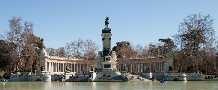 Low angle view of column at buen retiro park against clear sky during sunny day