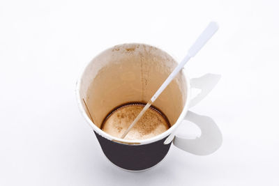 High angle view of coffee cup against white background